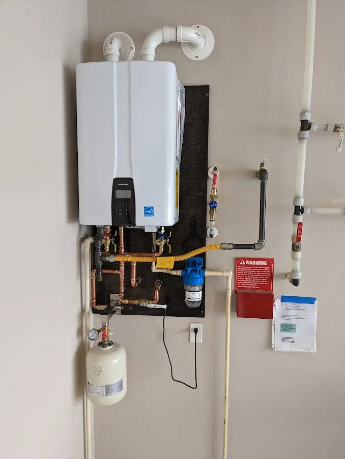 Professional plumber installing copper piping in a Sachse home